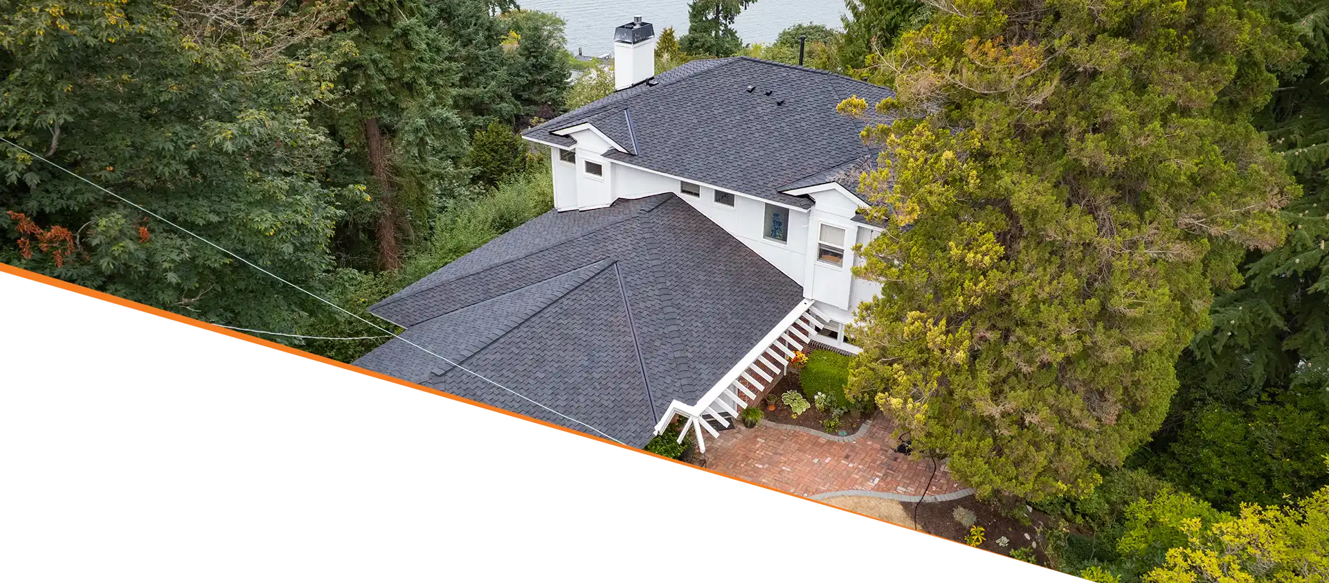 Aerial view of a modern house surrounded by trees.