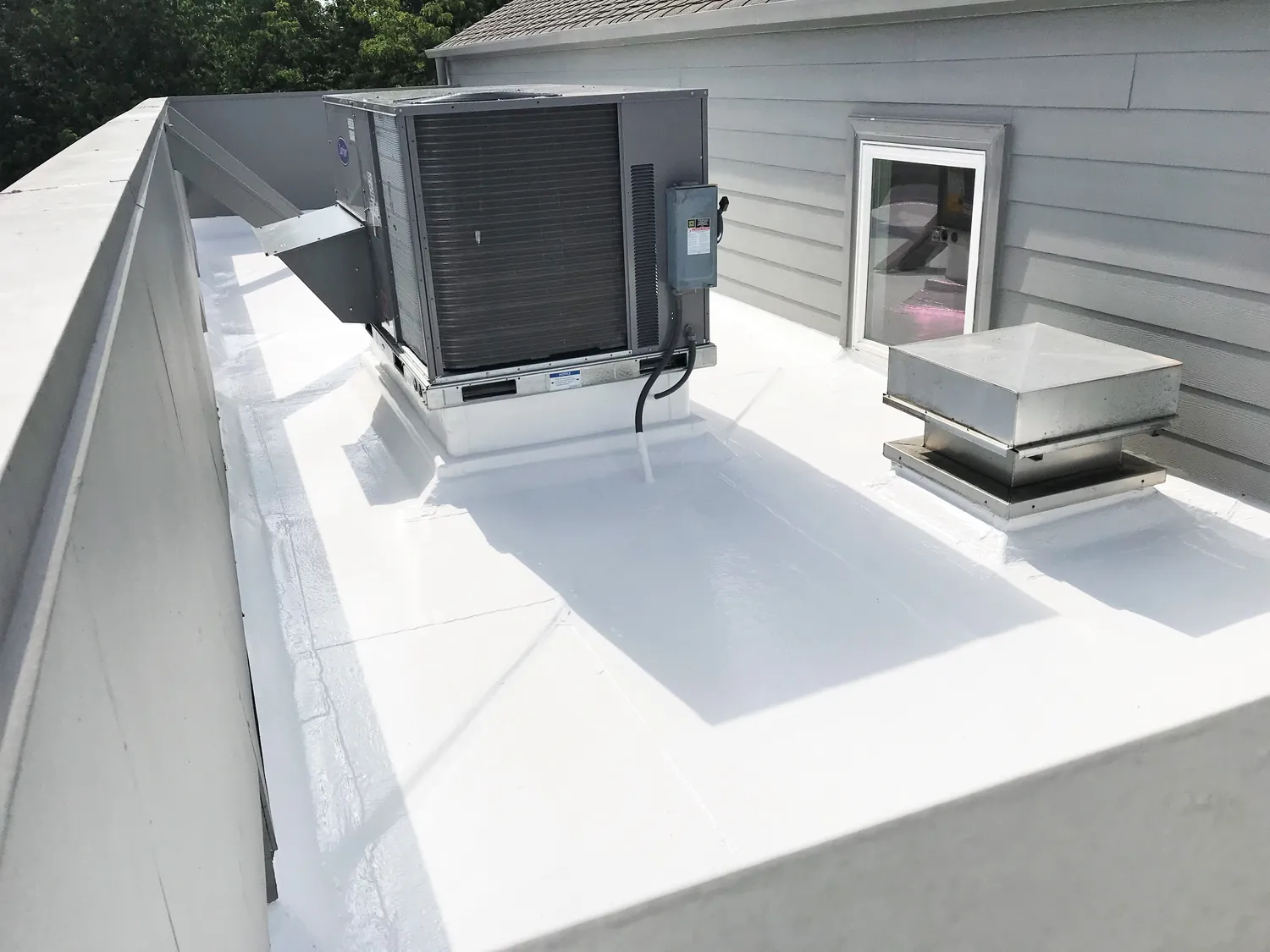 A rooftop with an air conditioning unit, a vent, and a window.